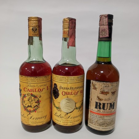 Lotto di due bottiglie di Brandy Carlos I e II e una di Rum Antille