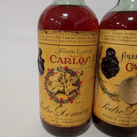 Lotto di due bottiglie di Brandy Carlos I e II e una di Rum Antille