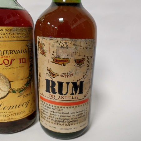 Lotto di due bottiglie di Brandy Carlos I e II e una di Rum Antille