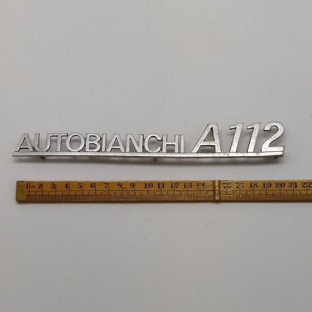 Fregio Autobianchi A 112 in metallo con segni di ossidazione
